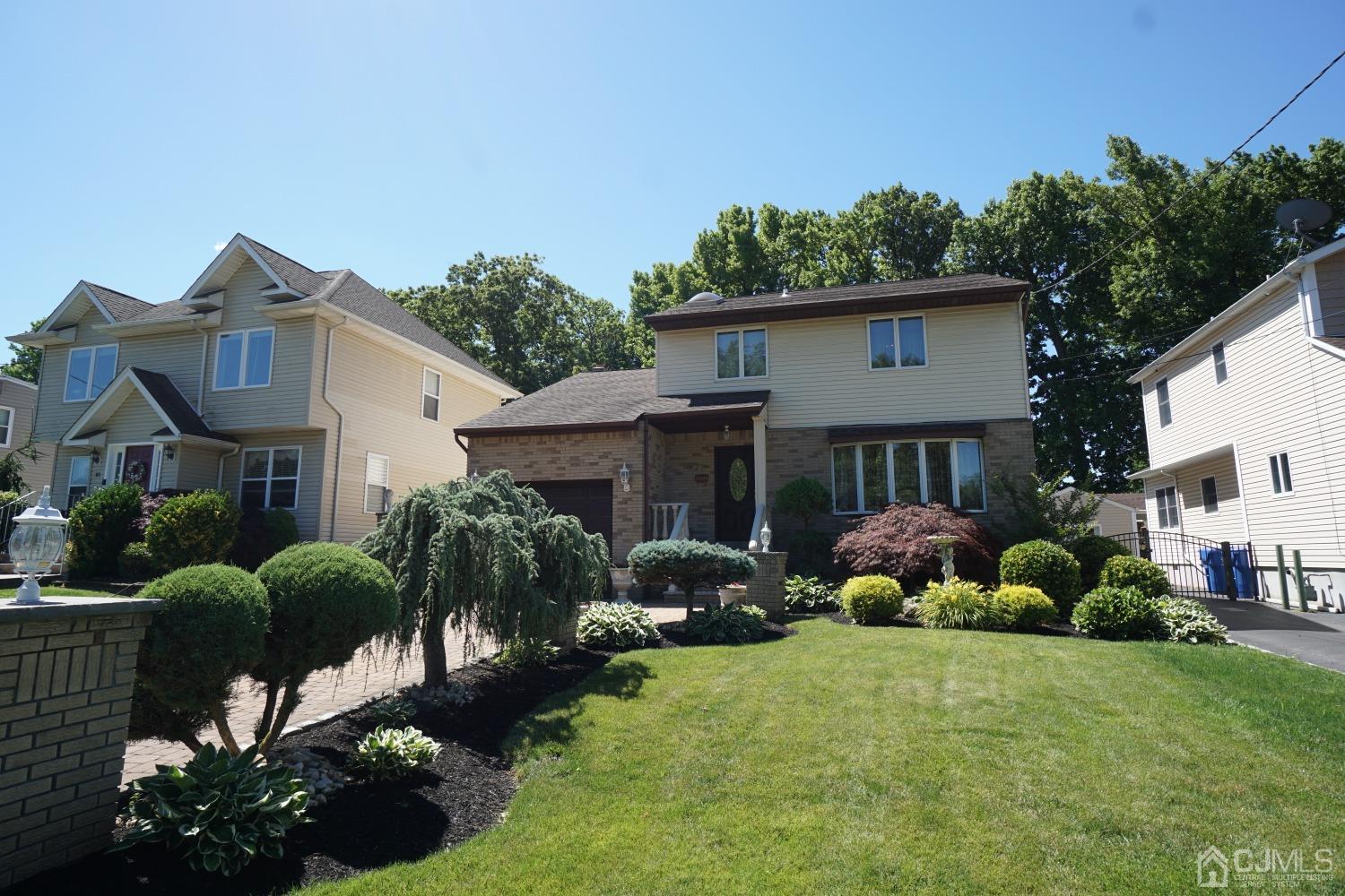 77 Inwood Avenue Colonia, NJ 07067 - Photo 33 of 37 a front view of house with yard and green space