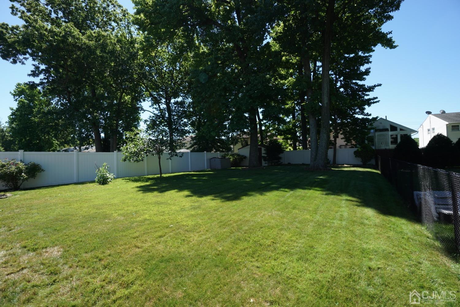 77 Inwood Avenue Colonia, NJ 07067 - Photo 36 of 37 a backyard of a house with lots of green space
