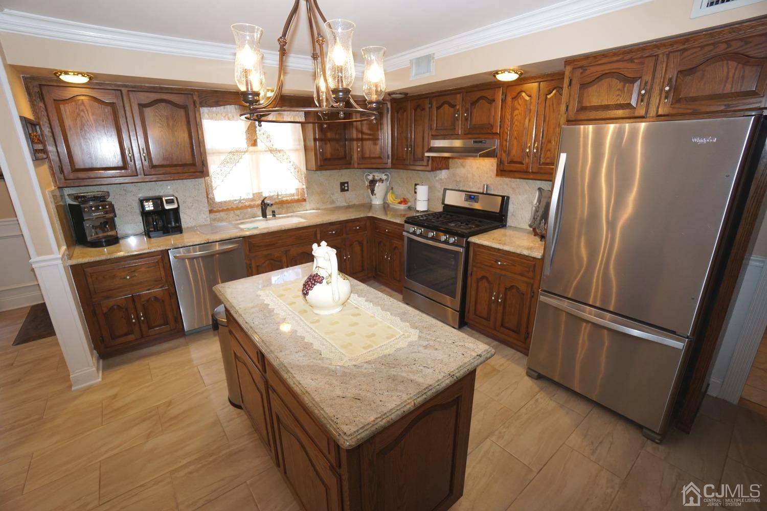 77 Inwood Avenue Colonia, NJ 07067 - Photo 8 of 37 a kitchen with granite countertop stainless steel appliances and wooden cabinets