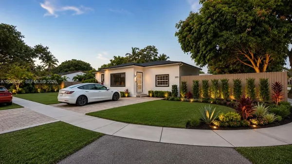 a view of a house with backyard and a garden