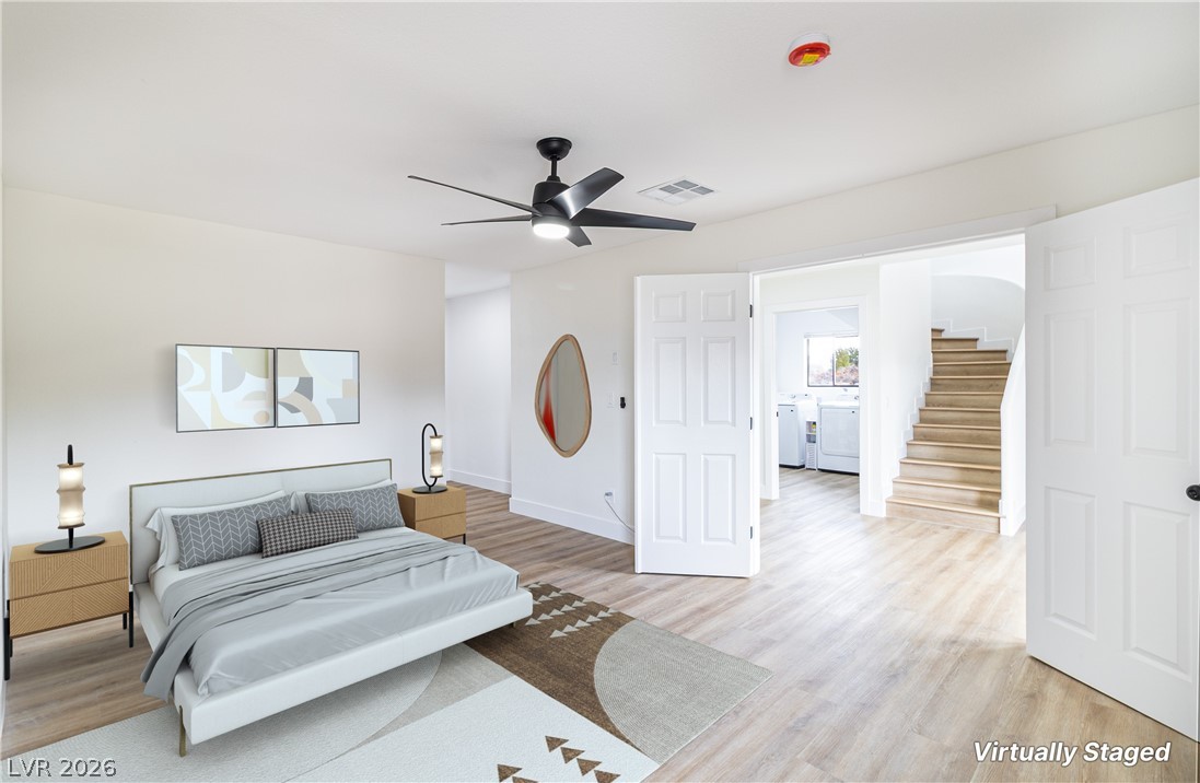 1891 Brian Road Pahrump, NV 89048 - Photo 14 of 50 Bedroom with a ceiling fan, visible vents, light wood finished floors, baseboards, and separate washer and dryer