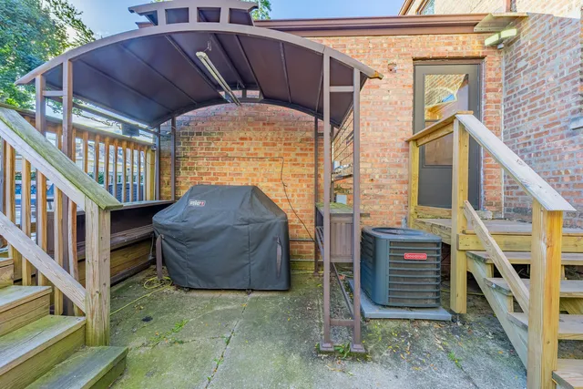 a view of a roof deck with table and chairs and wooden floor