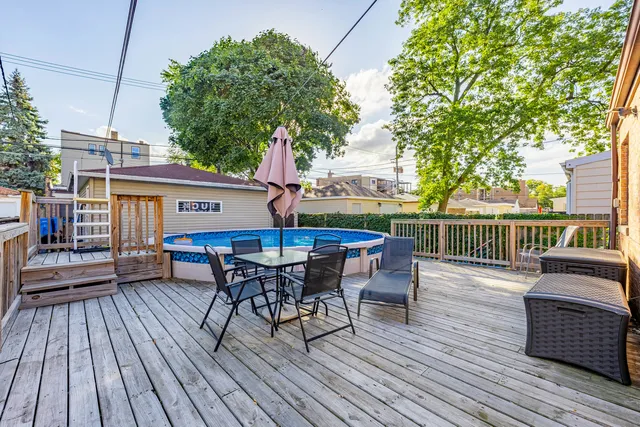 a view of a house with pool and sitting area