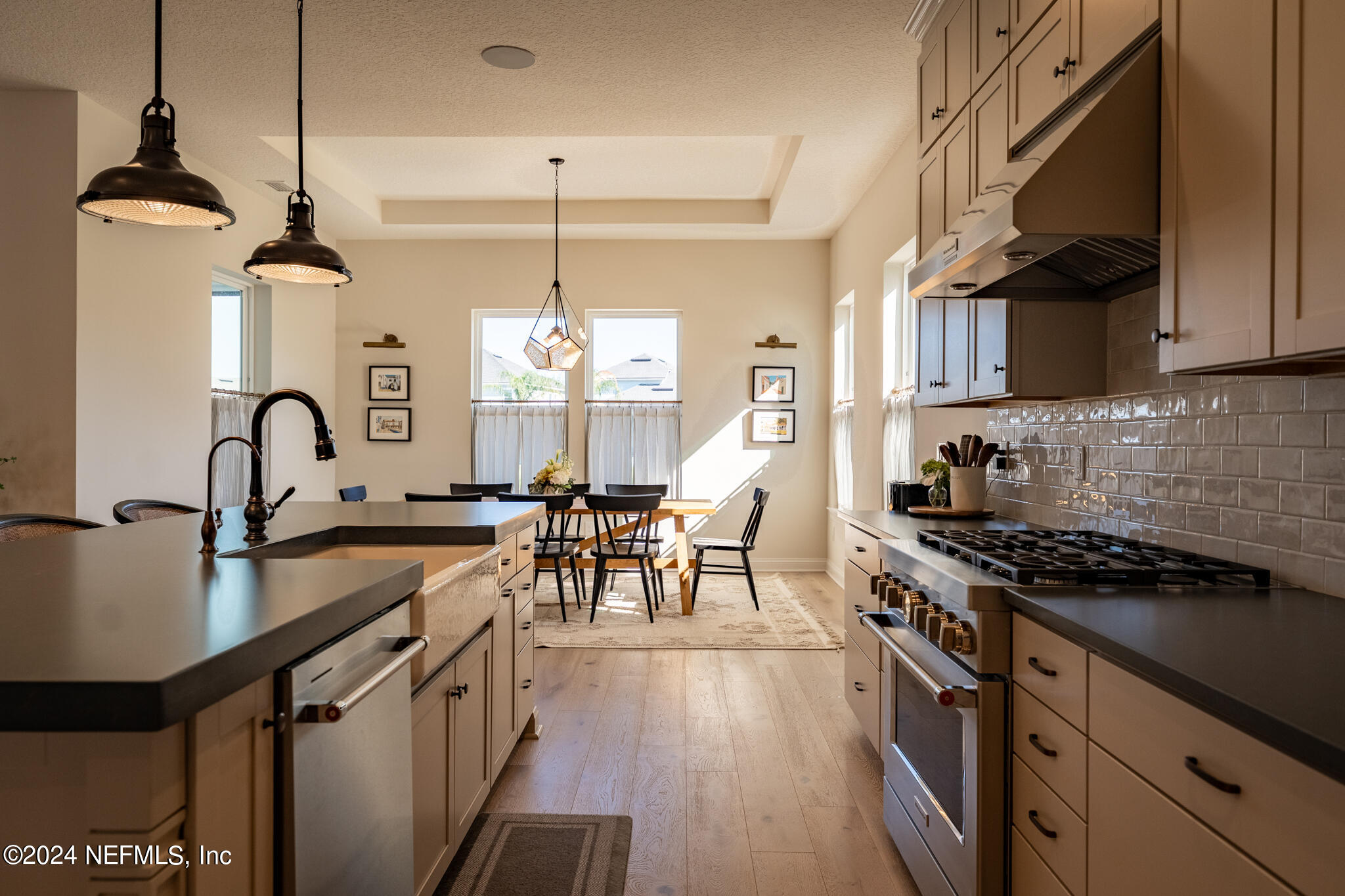 88 Awlleaf Court St. Augustine, FL 32095 - Photo 17 of 107 a kitchen with granite countertop a stove a sink a refrigerator and a wooden cabinets