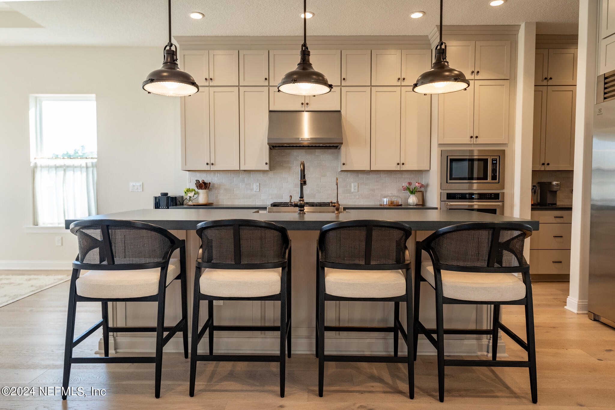 88 Awlleaf Court St. Augustine, FL 32095 - Photo 18 of 107 a kitchen with stainless steel appliances a dining table chairs and white cabinets