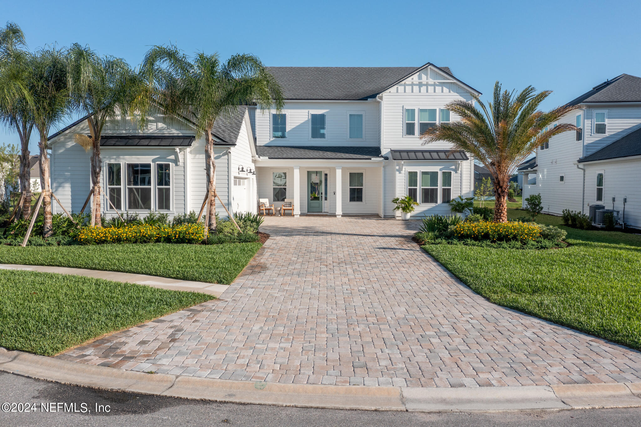 88 Awlleaf Court St. Augustine, FL 32095 - Photo 2 of 107 a front view of a house with a garden and trees