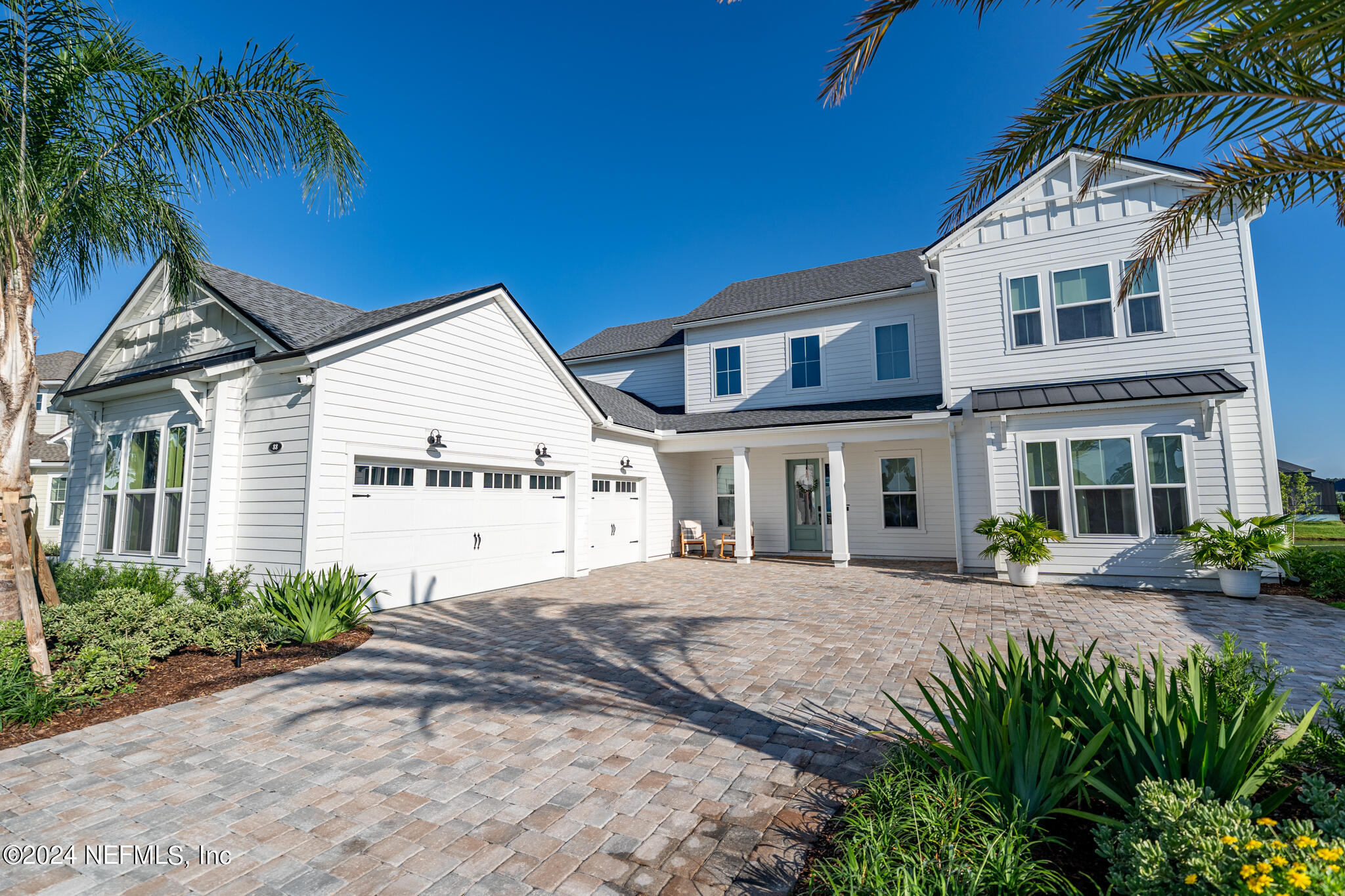 88 Awlleaf Court St. Augustine, FL 32095 - Photo 4 of 107 a view of a white house with a big yard and potted plants