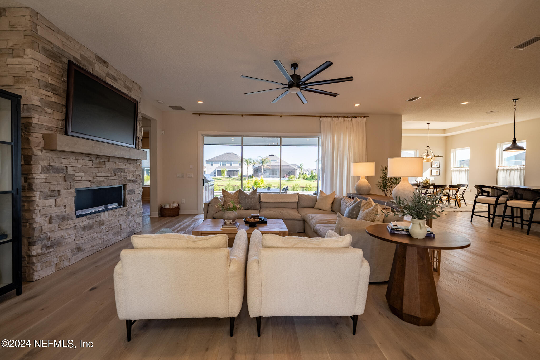 88 Awlleaf Court St. Augustine, FL 32095 - Photo 46 of 107 a living room with furniture a fireplace and a flat screen tv