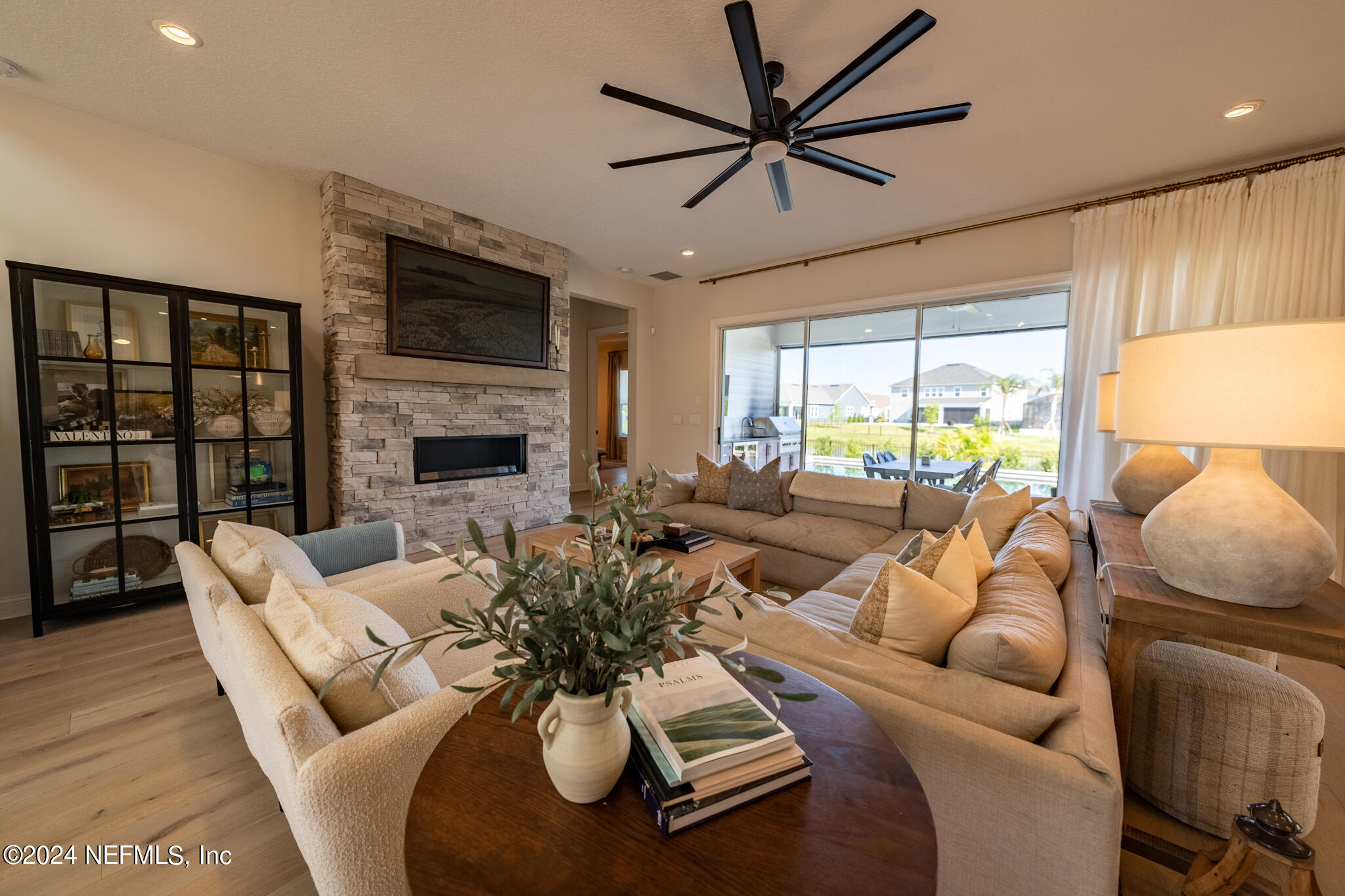 88 Awlleaf Court St. Augustine, FL 32095 - Photo 47 of 107 a living room with furniture a fireplace and a flat screen tv