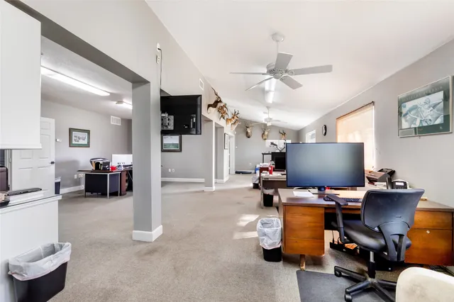 a working room with furniture and a flat screen tv