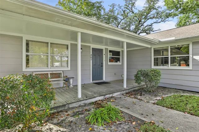 front view of a house with potted plants