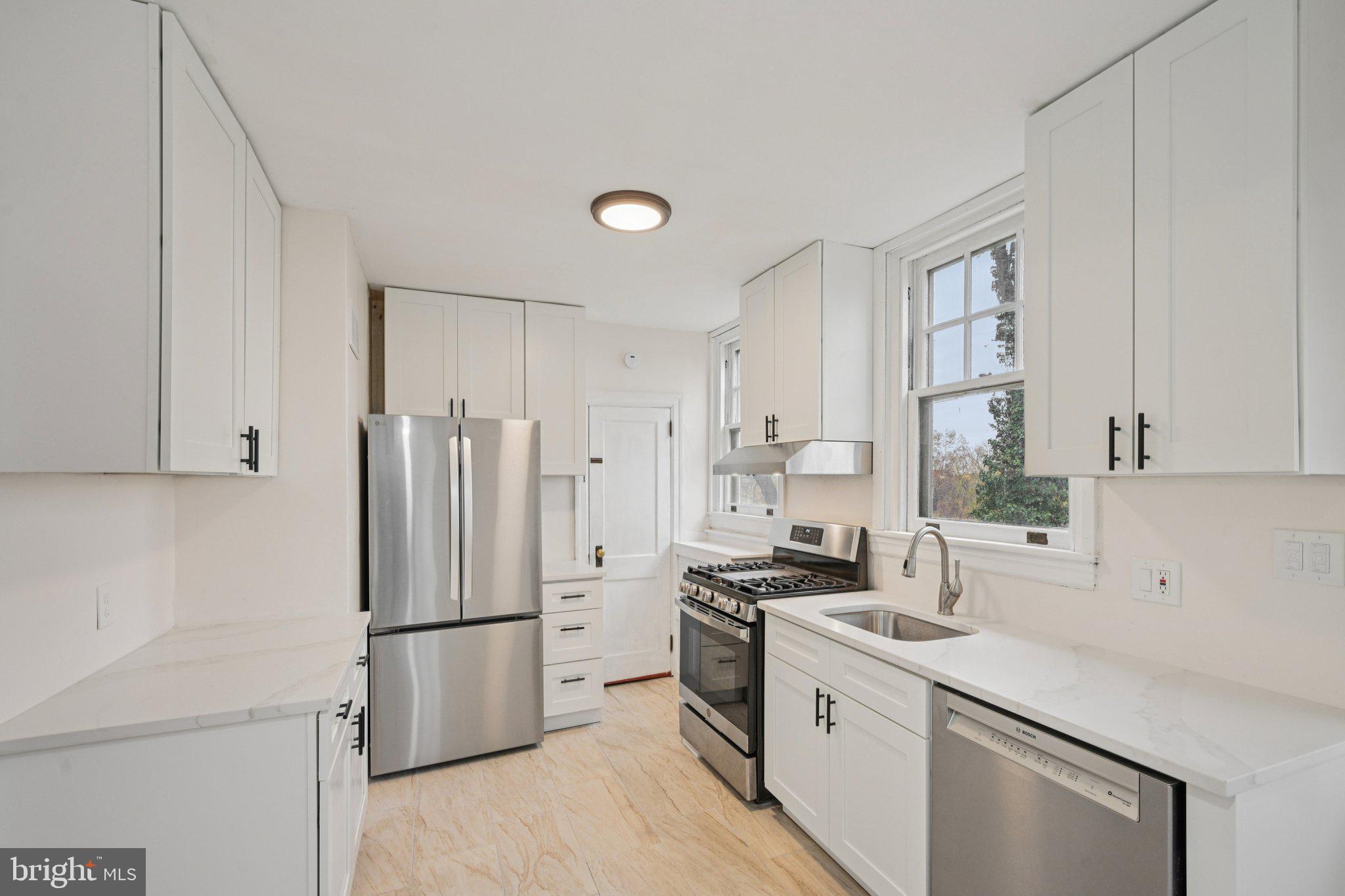 908 Edge Hill Road Glenside, PA 19038 - Photo 11 of 27 a kitchen with a white cabinets and white appliances