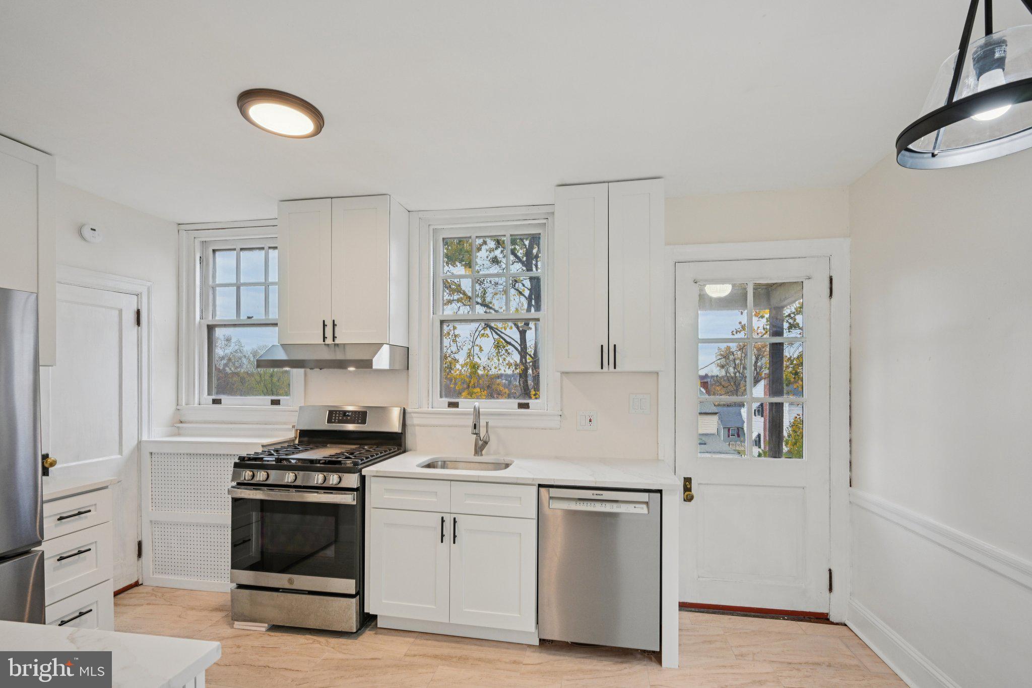 908 Edge Hill Road Glenside, PA 19038 - Photo 13 of 27 a kitchen with stainless steel appliances a cabinets and a stove top oven