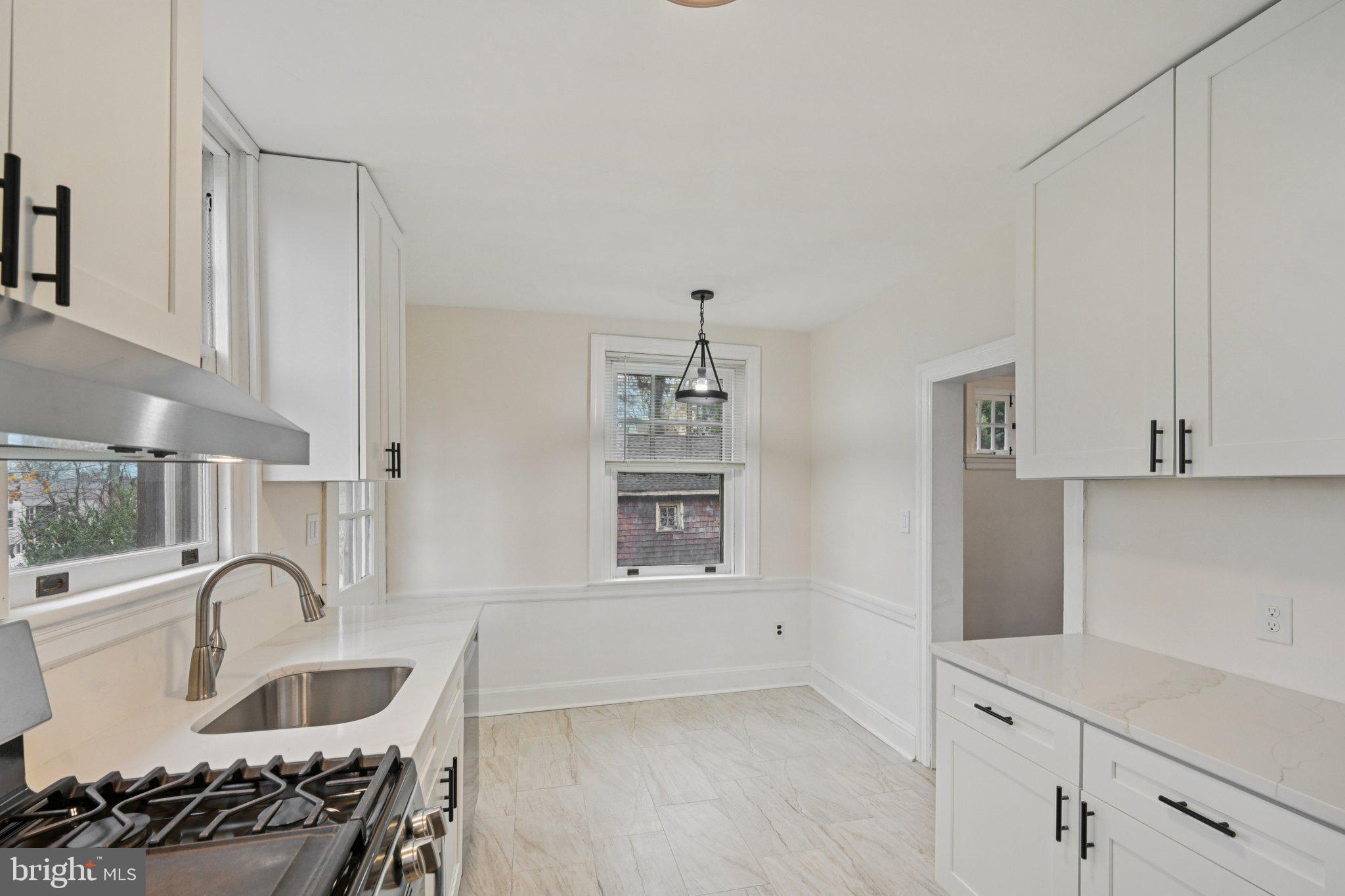 908 Edge Hill Road Glenside, PA 19038 - Photo 14 of 27 a kitchen with white cabinets and stove