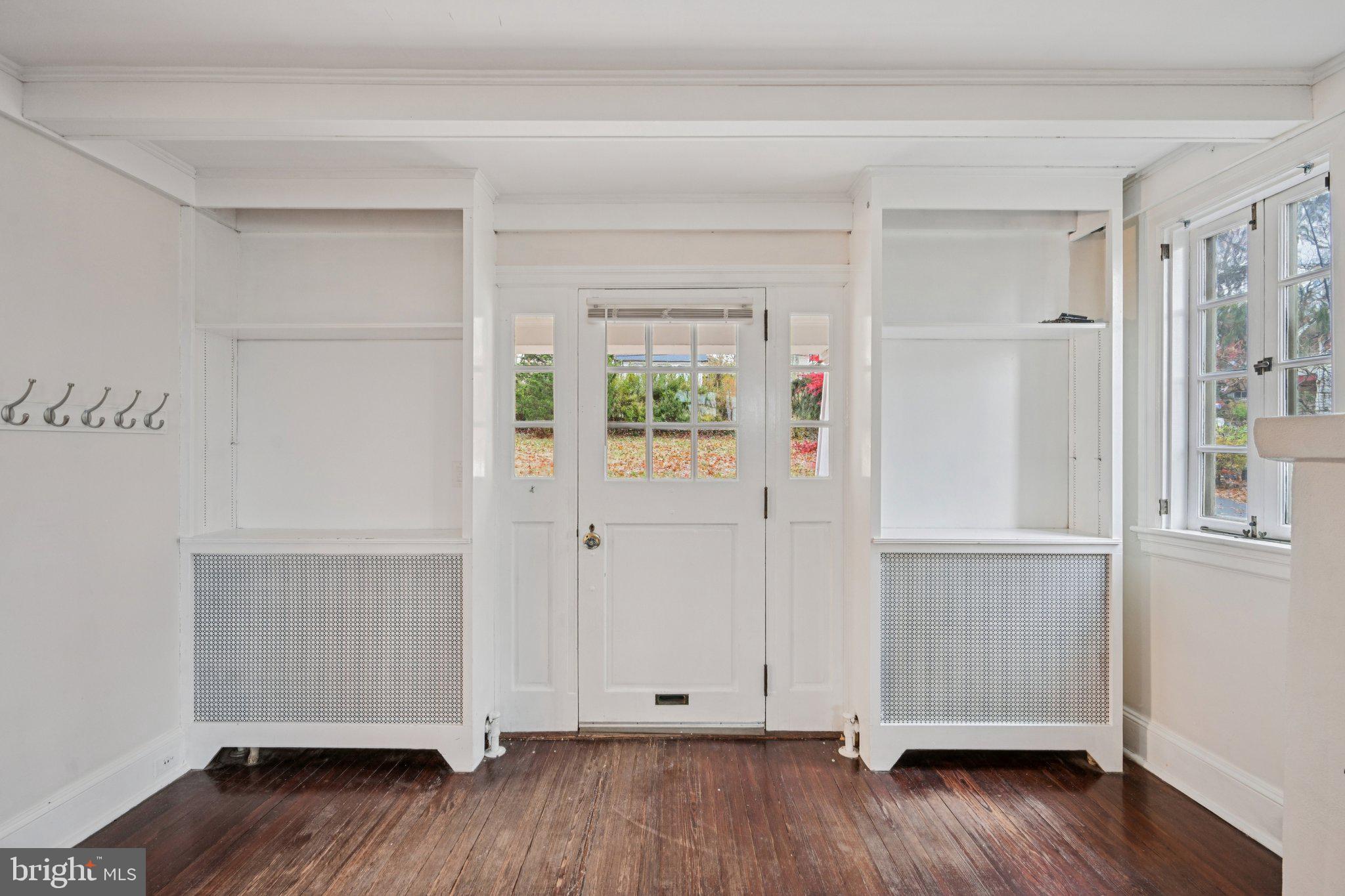 908 Edge Hill Road Glenside, PA 19038 - Photo 15 of 27 an empty room with wooden floor and windows