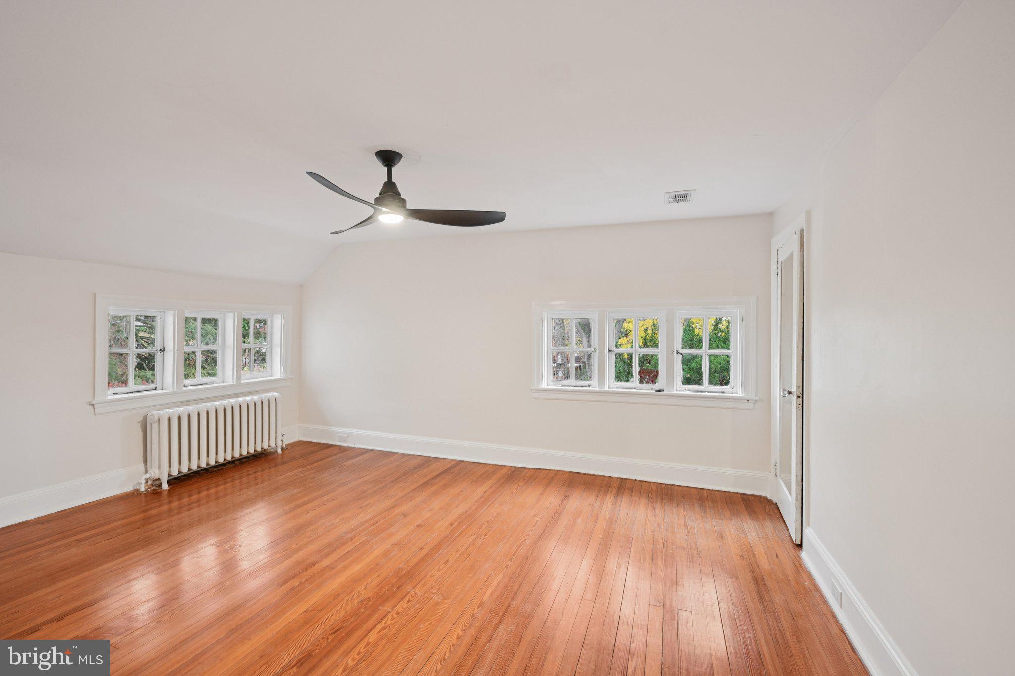 908 Edge Hill Road Glenside, PA 19038 - Photo 16 of 27 wooden floor in an empty room with a window