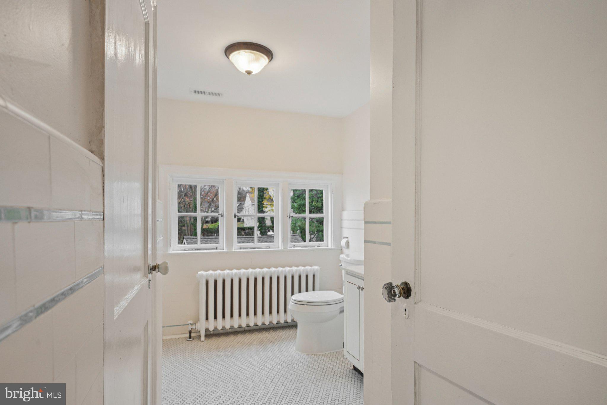 908 Edge Hill Road Glenside, PA 19038 - Photo 19 of 27 a view of a room with a white walls and a window