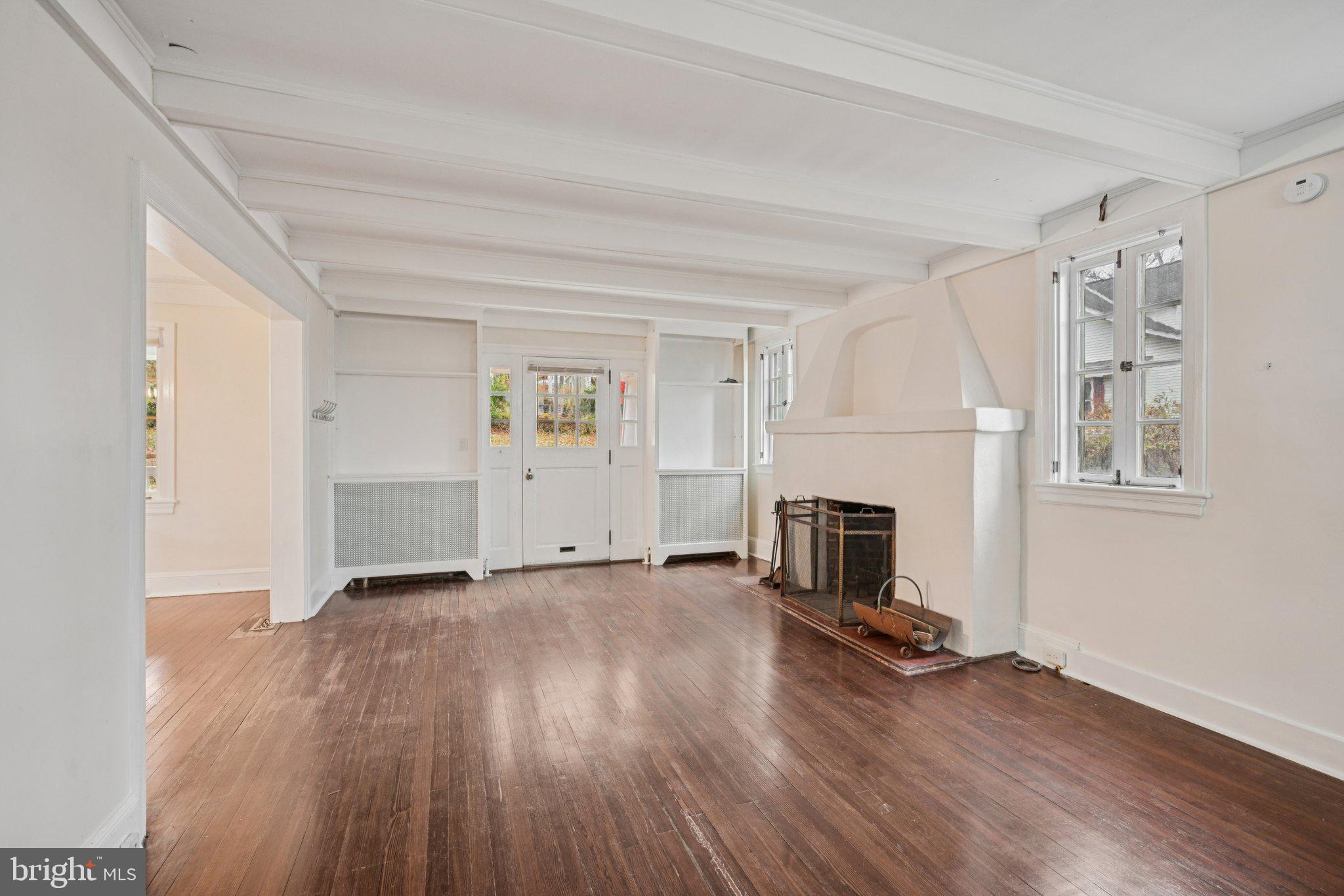 908 Edge Hill Road Glenside, PA 19038 - Photo 7 of 27 a view of a livingroom with wooden floor and a fireplace