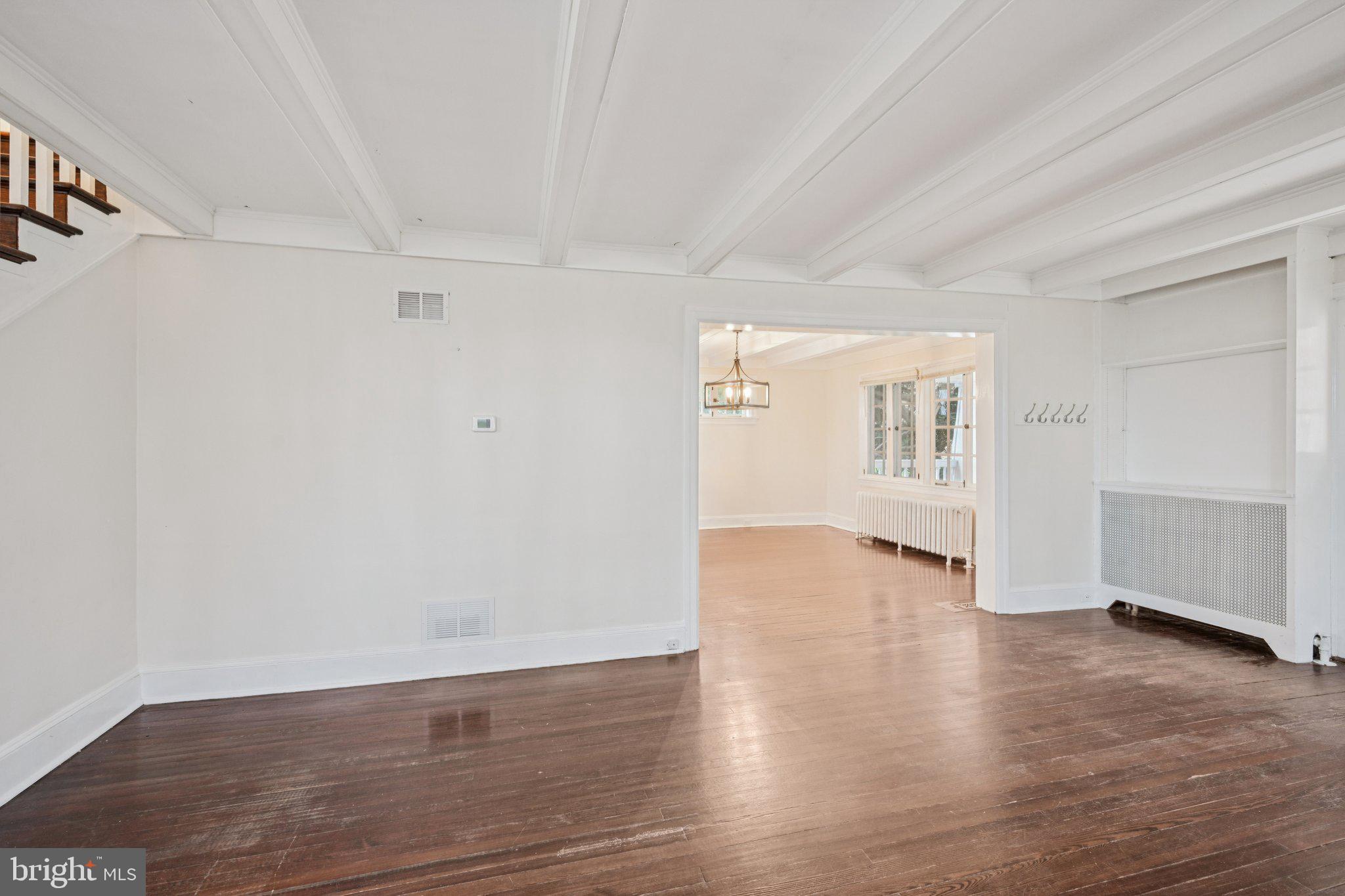 908 Edge Hill Road Glenside, PA 19038 - Photo 8 of 27 an empty room with wooden floor white walls and windows