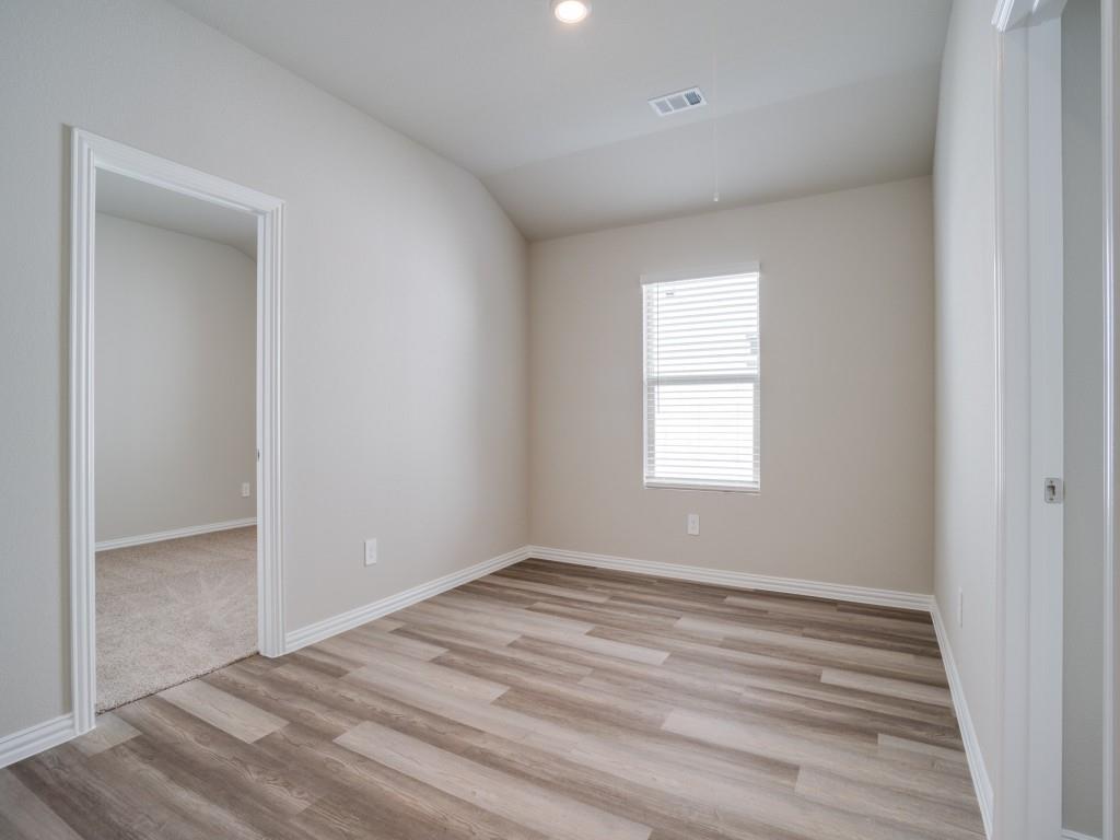 808 Tidal Drive McKinney, TX 75071 - Photo 20 of 26 an empty room with wooden floor and windows