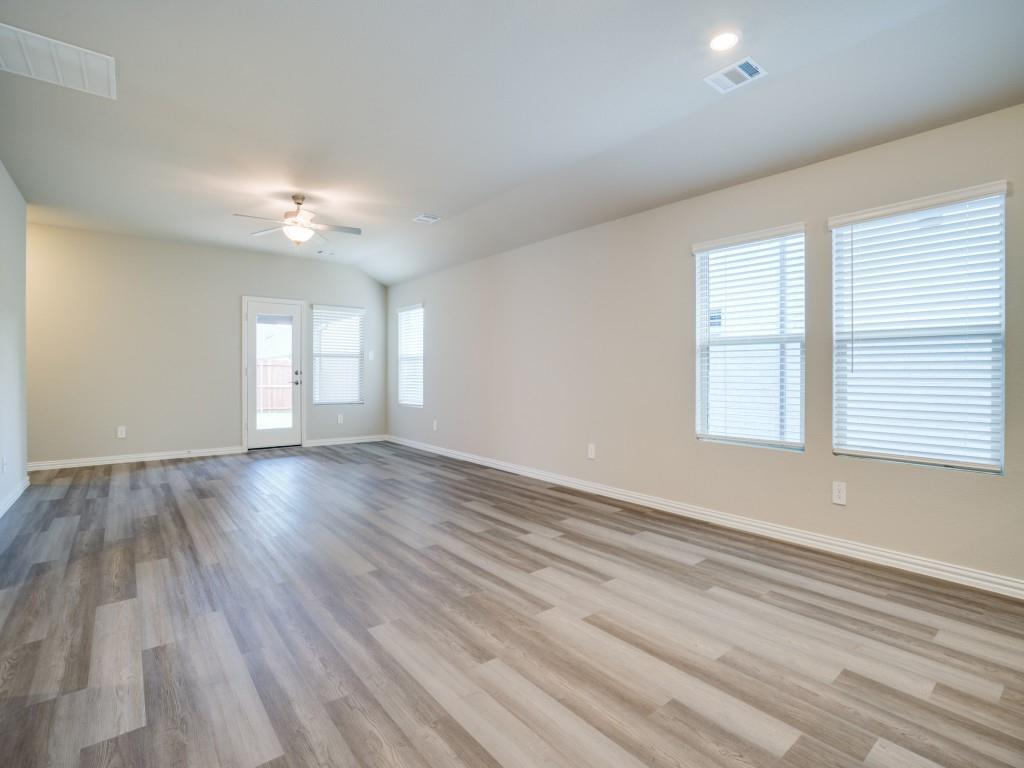 808 Tidal Drive McKinney, TX 75071 - Photo 4 of 26 wooden floor in an empty room with a window