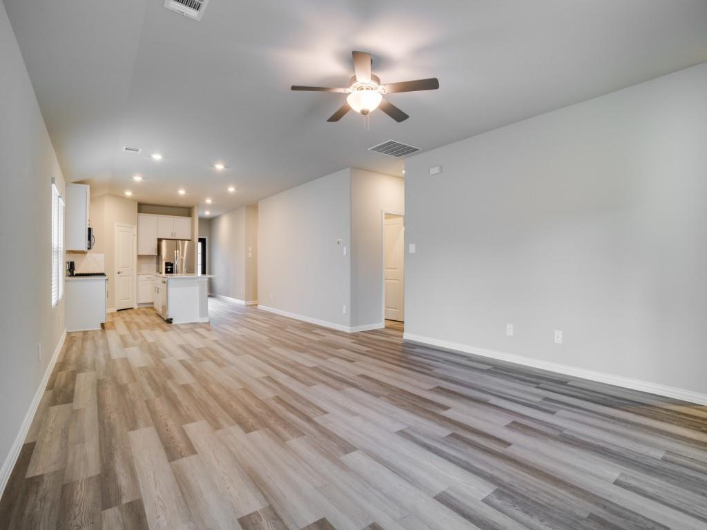 808 Tidal Drive McKinney, TX 75071 - Photo 7 of 26 a view of a kitchen with a sink and a refrigerator