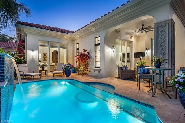 a view of a livingroom with furniture and floor to ceiling window