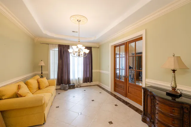 a living room with furniture and a chandelier