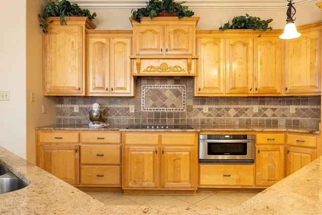 a kitchen with stainless steel appliances granite countertop a sink and cabinets