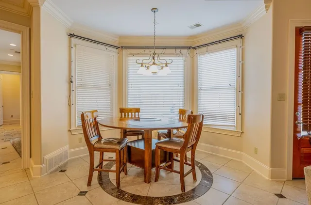 a large kitchen with kitchen island a large counter space a sink and appliances