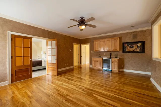 a view of a livingroom with furniture a ceiling fan and window