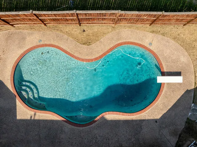 a view of a swimming pool with a garden