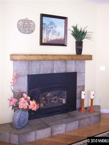 4931 Lakeridge Terrace West Reno, NV 89509 - Photo 6 of 9 a living room with a fireplace and flowers