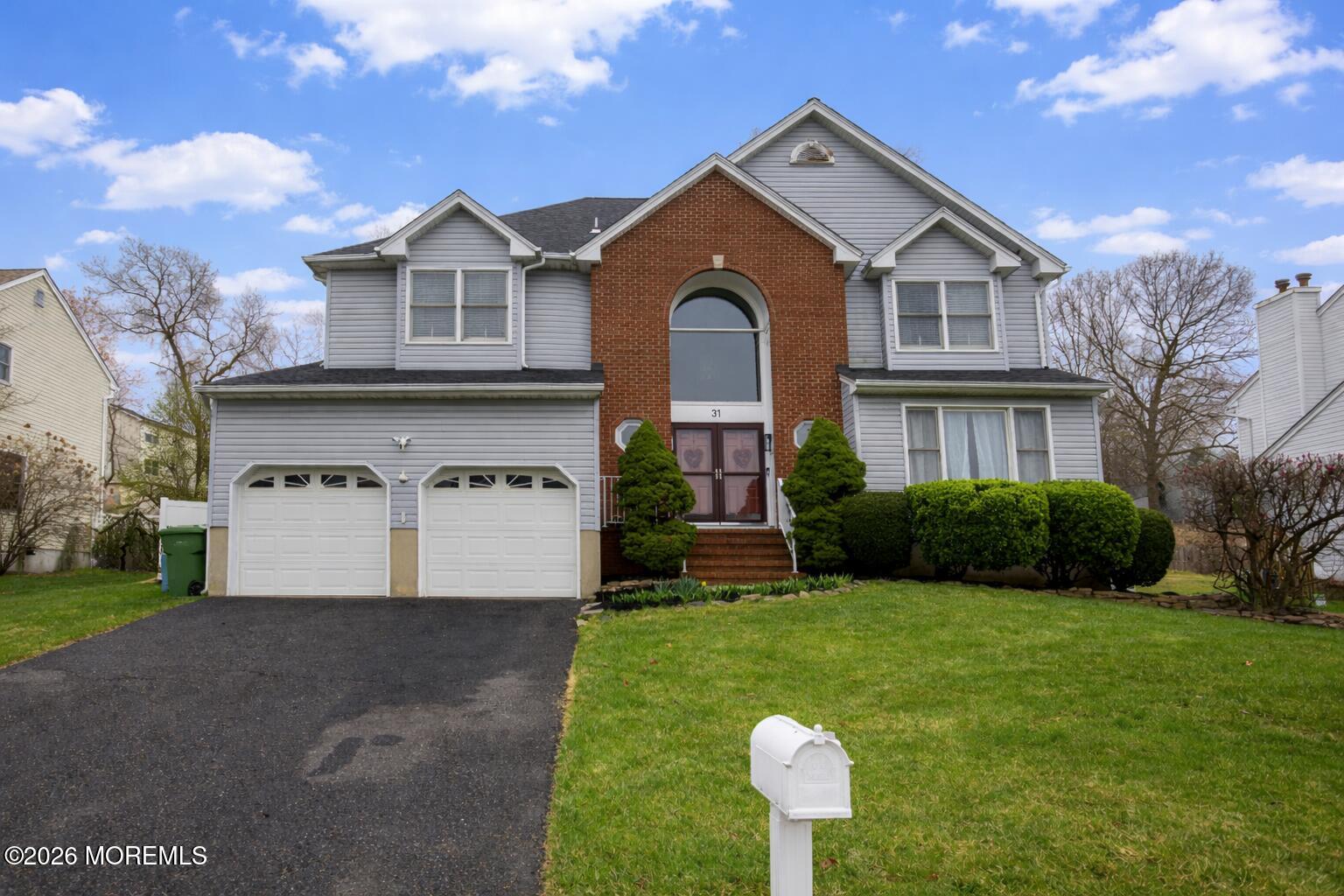 a front view of a house with a yard and garage