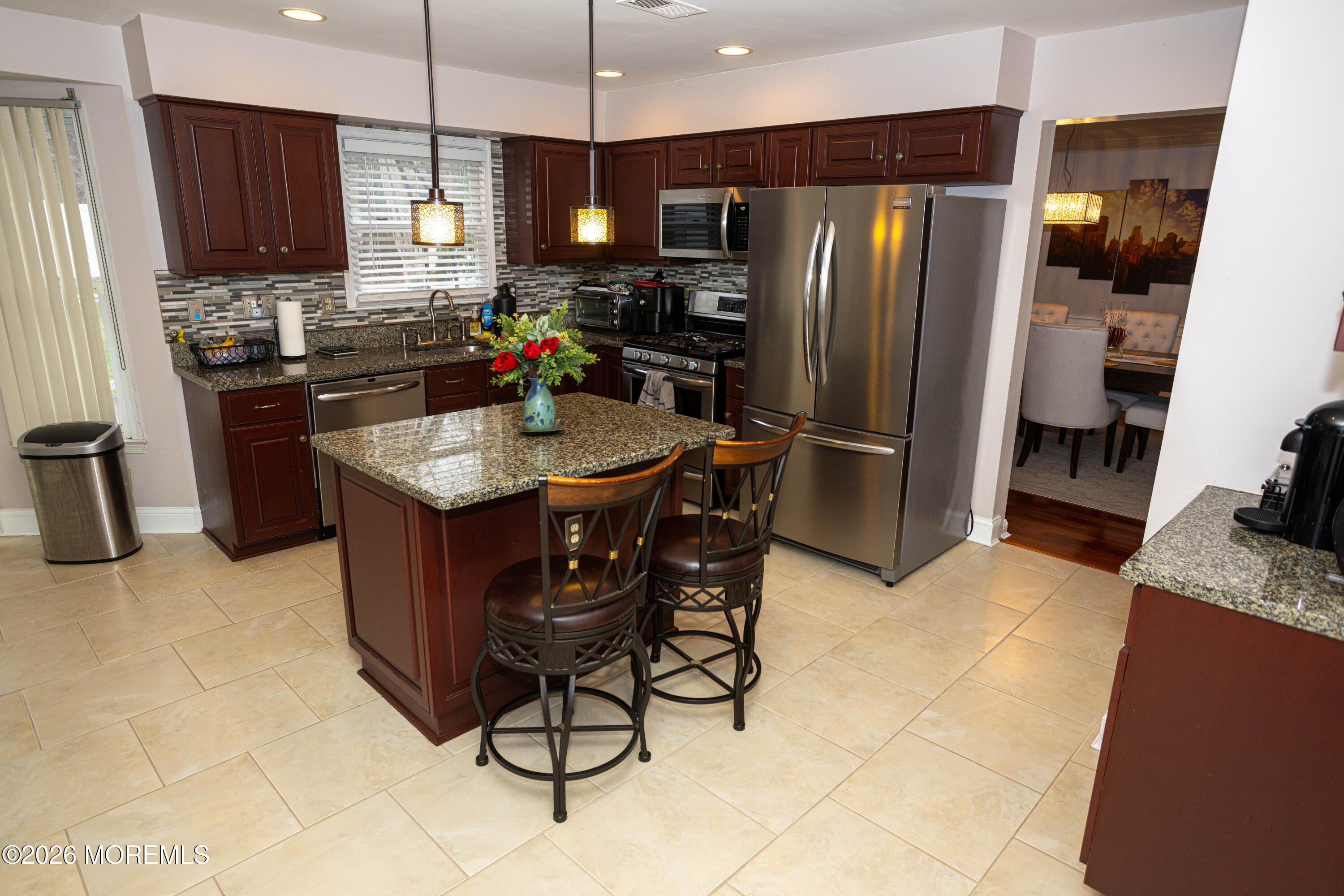 31 Scarlet Drive Parlin, NJ 08859 - Photo 20 of 67 a kitchen with stainless steel appliances granite countertop a refrigerator a sink a stove a dining table and chairs