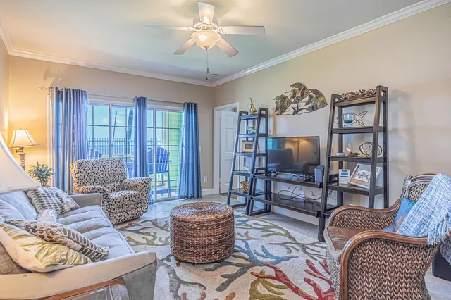 a living room with furniture a flat screen tv and a large window