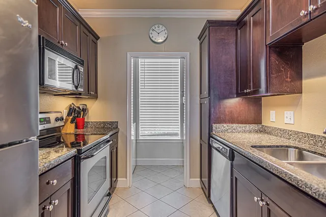 a kitchen with stainless steel appliances granite countertop a sink stove and cabinets