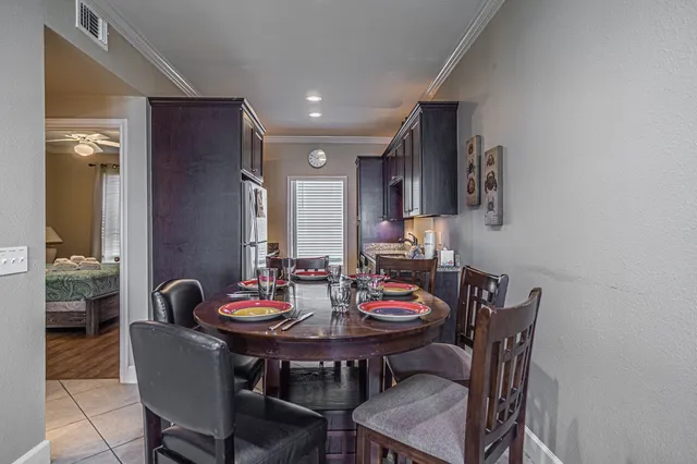 a view of a dining room with furniture and a potted plant