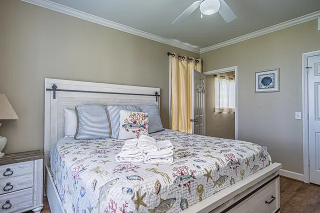 a bedroom with a large bed and a chandelier