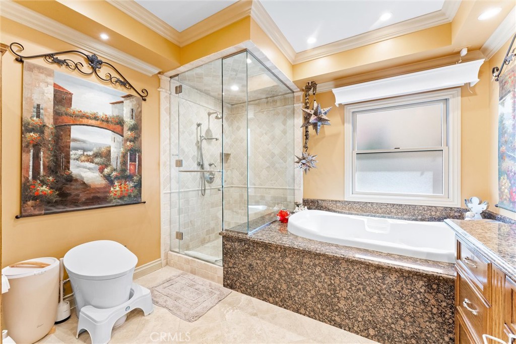 3781 Ragtime Circle Huntington Beach, CA 92649 - Photo 14 of 55 a bathroom with a bathtub a toilet and a shower