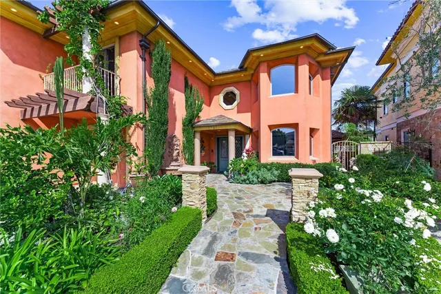 a front view of a multi story residential apartment building with yard and sign board