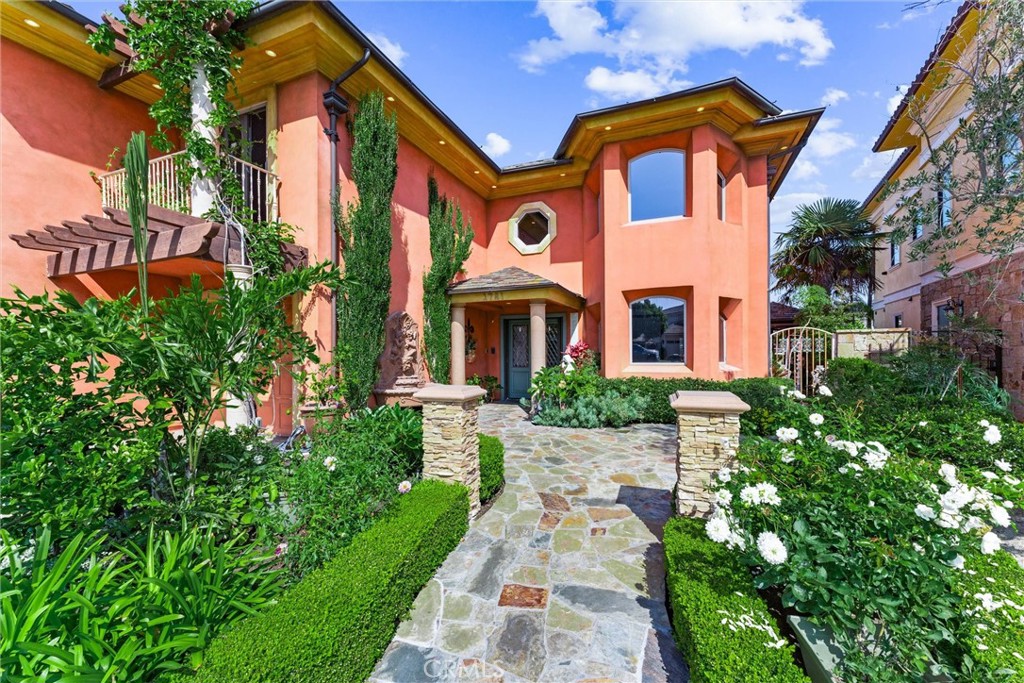 3781 Ragtime Circle Huntington Beach, CA 92649 - Photo 3 of 55 a front view of a multi story residential apartment building with yard and sign board