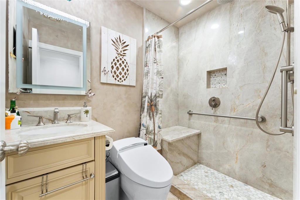 3781 Ragtime Circle Huntington Beach, CA 92649 - Photo 37 of 55 a bathroom with a sink toilet vanity and shower