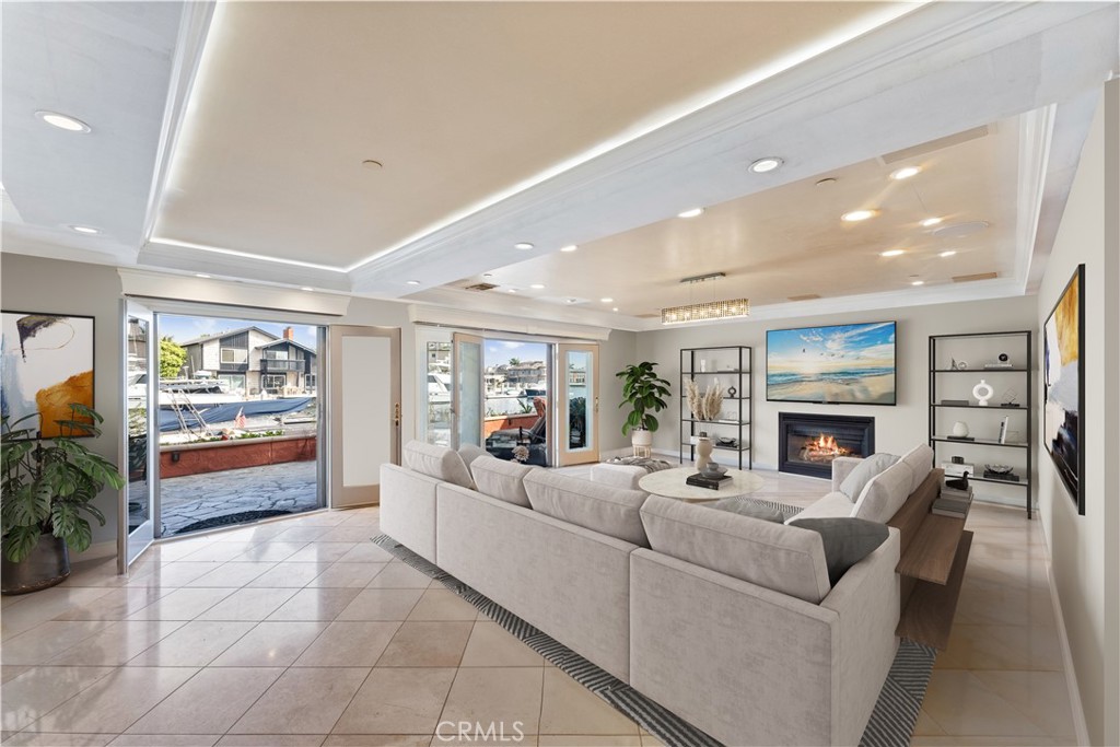 3781 Ragtime Circle Huntington Beach, CA 92649 - Photo 7 of 55 a living room with fireplace furniture and a flat screen tv