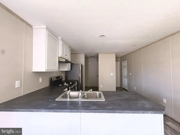 a view of a kitchen with a sink and a cabinets