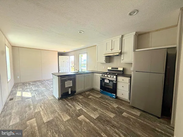 a kitchen with refrigerator cabinets and a counter top space