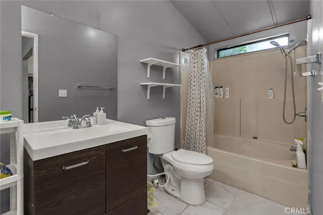 a bathroom with a sink toilet vanity and shower