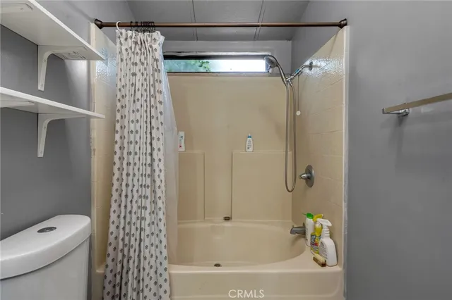 a bathroom with a shower and a toilet