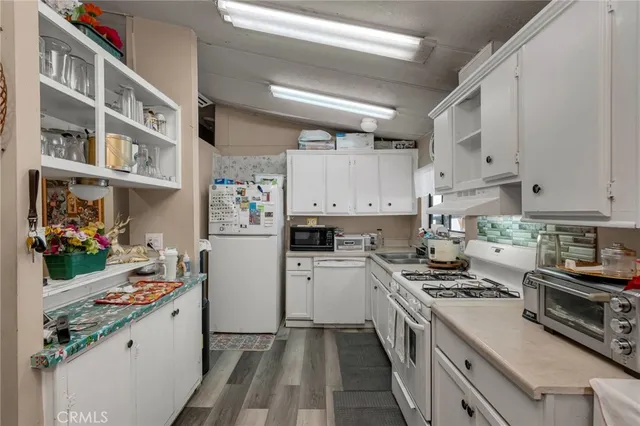 a kitchen with stainless steel appliances a stove a sink and a refrigerator