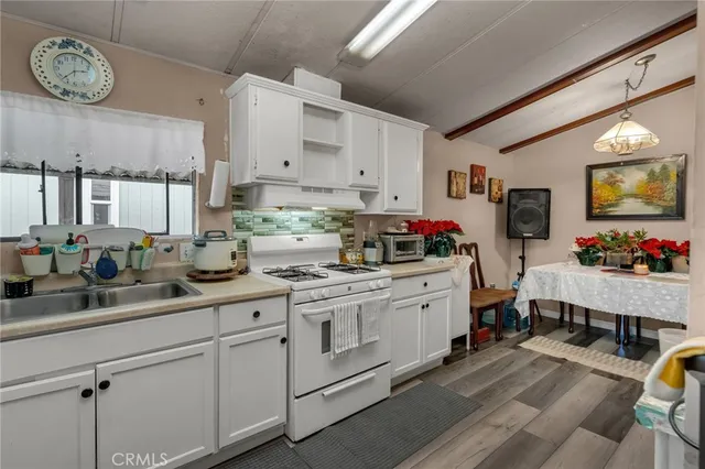 a kitchen with cabinets appliances and a counter top space